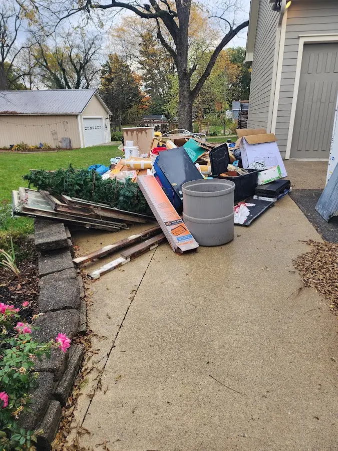 Dumpster being loaded with debris for 12 Yard Dumpster Rental in Elgin
